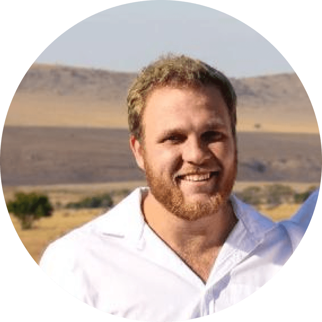 Headshot of Vincent Stockigt, co-director of STC Motion in a white shirt, set against a picturesque field landscape.