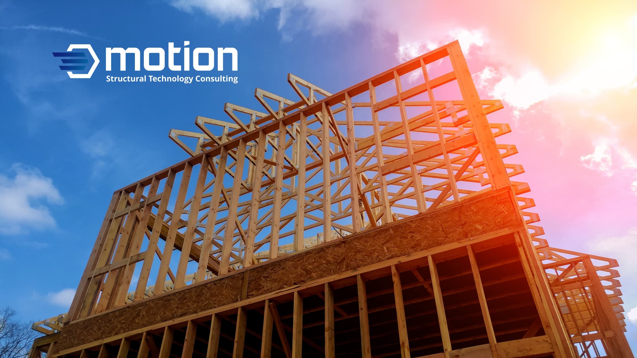 A timber building frame image with STC Motion's logo, illustrating the variety of structural engineering services provided.